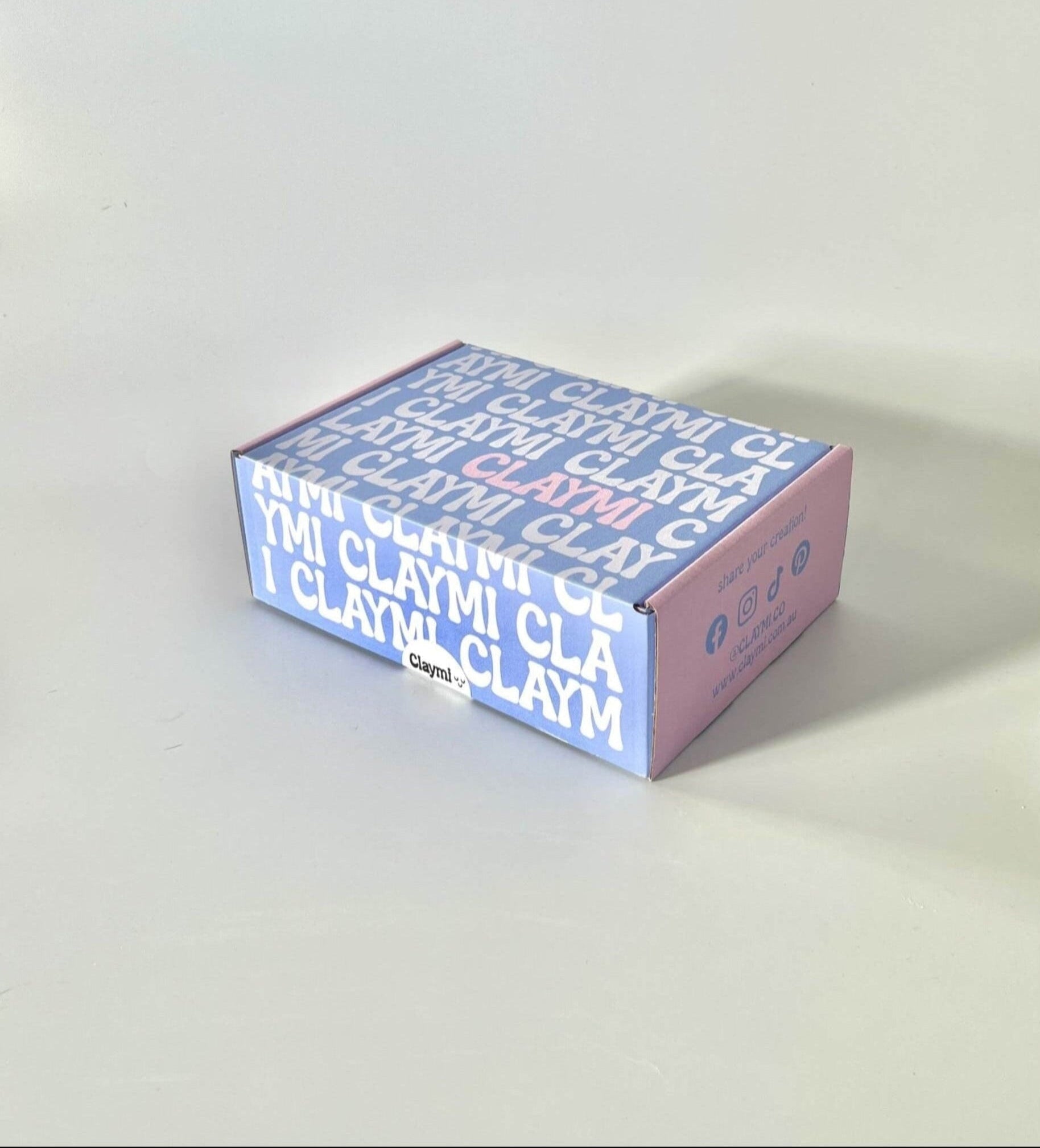 Claymi product packaging box on a light gray background